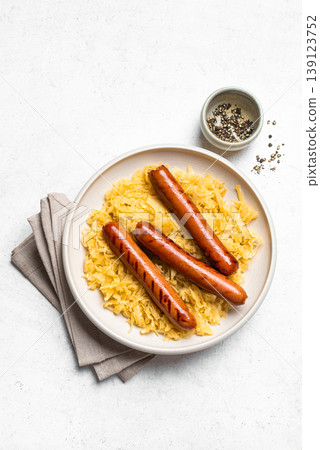 Stewed cabbage, sauerkraut and grilled sausages bratwurst Stewed cabbage, sauerkraut and grilled sausages bratwurst 139123752
