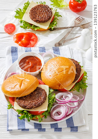 Beef cheeseburgers with brioche buns on a plate Beef cheeseburgers with brioche buns on a plate 139123763