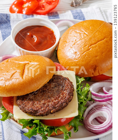 Beef cheeseburgers with brioche buns on a plate Beef cheeseburgers with brioche buns on a plate 139123765
