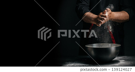 Chef clapping hands with flour over bowl on dark background baking concept with copy space 139124027
