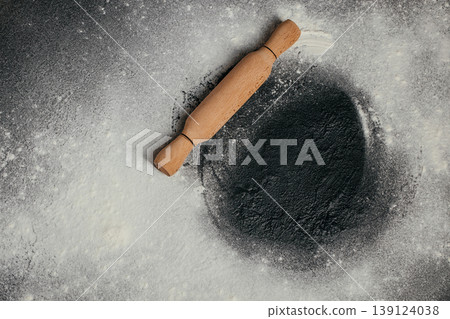 Rolling pin on floured dark surface, baking background with copy space 139124038