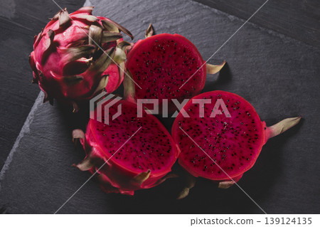 Dragon fruit on a grey granite background. Dragon fruit on a grey granite background. 139124135