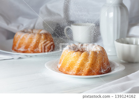 Traditional vanilla pound cake with orange extract on a white wooden table. Traditional vanilla pound cake with orange extract on a white wooden table. 139124162