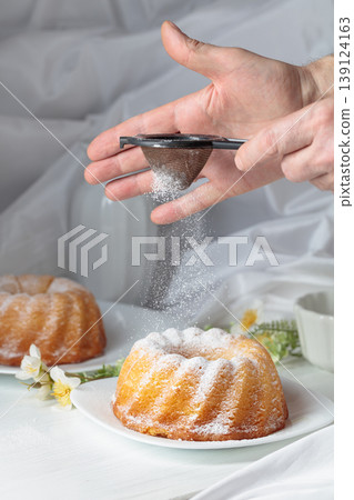 Traditional vanilla pound cake with orange extract on a white wooden table. Traditional vanilla pound cake with orange extract on a white wooden table. 139124163