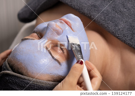 Woman gets blue mask for skin care 139124177