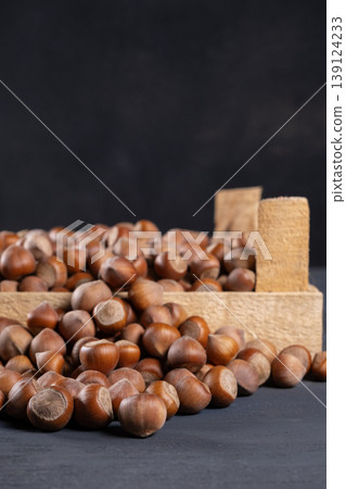 Pile of hazelnuts in a wooden crate. Pile of hazelnuts in a wooden crate. 139124233