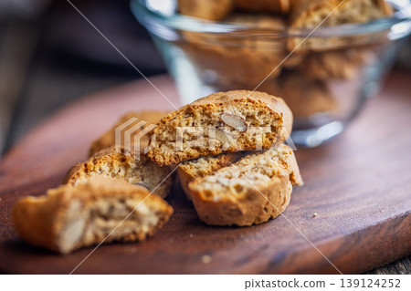 Crunchy Almond Biscotti Cookies cantuccini on Wooden Board With Glass Bowl Rustic Italian Snack Crunchy Almond Biscotti Cookies cantuccini on Wooden Board With Glass Bowl Rustic Italian Snack 139124252