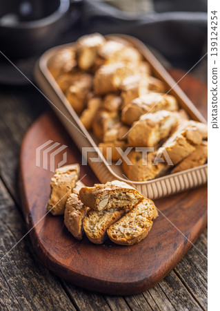 Crunchy Almond Biscotti cantuccini Stacked on Wooden Board With Tray of Italian Cookies for Coffee Time Crunchy Almond Biscotti cantuccini Stacked on Wooden Board With Tray of Italian Cookies for Coffee Time 139124254