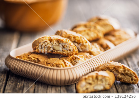 Crunchy Almond Biscotti cantuccini Stacked on Wooden Board With Tray of Italian Cookies for Coffee Time Crunchy Almond Biscotti cantuccini Stacked on Wooden Board With Tray of Italian Cookies for Coffee Time 139124256