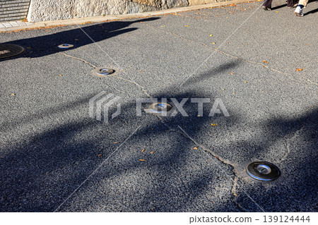 Retractable hydraulic bollard point ( Car barrier ) In unused mode on street pavement 139124444