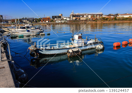Small fishing boats are docked in a coastal town near Kitakyushu, Japan. Small fishing boats are docked in a coastal town near Kitakyushu, Japan. 139124457