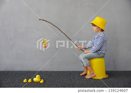 Happy child playing indoor. Kid enjoying a fishing trip. Little boy having fun at home Happy child playing indoor. Kid enjoying a fishing trip. Little boy having fun at home 139124607
