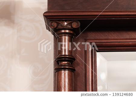 Ornate wooden mirror frame with carved column detail Ornate wooden mirror frame with carved column detail 139124680