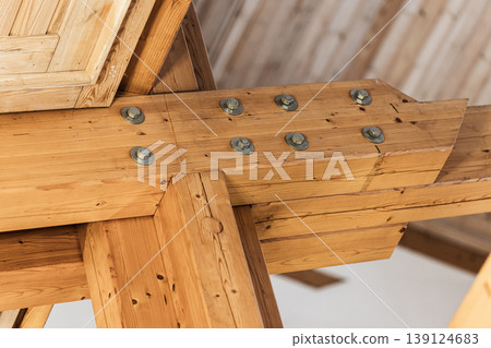 Timber frame ceiling showcasing intersecting heavy wooden beams Timber frame ceiling showcasing intersecting heavy wooden beams 139124683