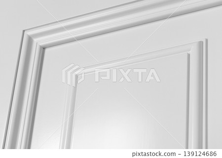 Close-up view of a white interior door panel showing decorative molding Close-up view of a white interior door panel showing decorative molding 139124686