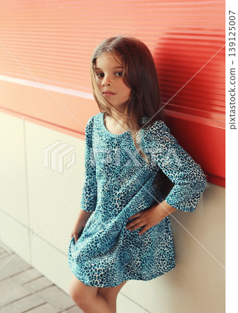 Beautiful little girl child wearing blue dress on city street Beautiful little girl child wearing blue dress on city street 139125007