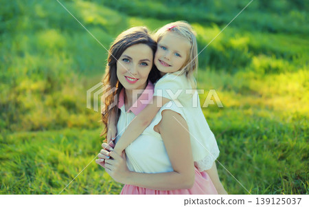 Happy smiling mother and child playing in summer park Happy smiling mother and child playing in summer park 139125037