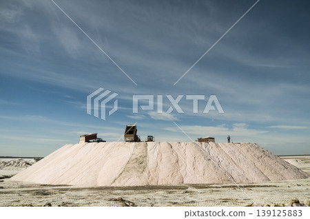 Trucks unloading raw salt bulk, Salinas Grandes de Hidalgo, La Pampa, Argentina. Trucks unloading raw salt bulk, Salinas Grandes de Hidalgo, La Pampa, Argentina. 139125883