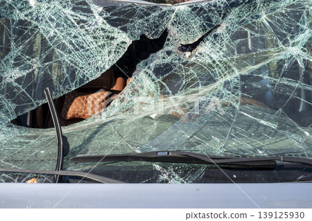 Damaged vehicle windshield close-up after crash. Broken windshield of a car after an accident. Damaged vehicle windshield close-up after crash. Broken windshield of a car after an accident. 139125930