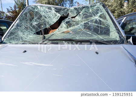 Damaged vehicle windshield close-up after crash. Broken windshield of a car after an accident. 139125931