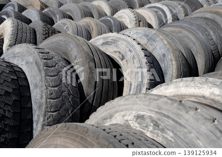 Pile of used car tires ready for recycling. Stacked old tires in a recycling yard. Pile of used car tires ready for recycling. Stacked old tires in a recycling yard. 139125934
