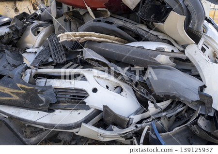 Old and damaged car bumpers collected for recycling. Old and damaged car bumpers collected for recycling. 139125937