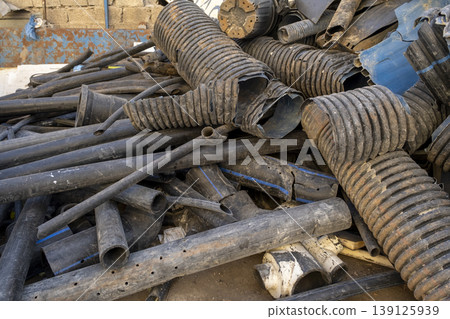 Used PVC Pipes Thrown Away at Scrap Site. Discarded Construction Pipes at Recycling Area. 139125939