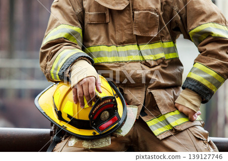 Exhausted Asian firefighter resting after finishing a rescue mission 139127746