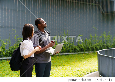 Business colleagues working together on laptop in urban area 139128215