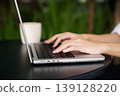 Close up woman hands typing on laptop in modern workspace 139128220