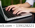 Close up woman hands typing on laptop in modern workspace 139128221