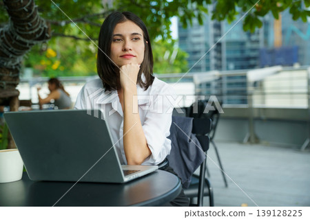 Woman working remotely on laptop in modern outdoor workspace 139128225