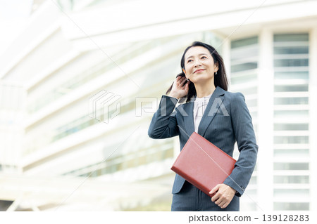 拿著筆記本微笑的女商人 139128283