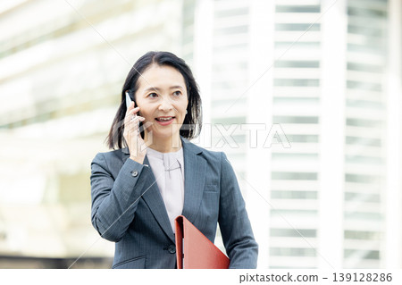 Business woman with a smartphone Business woman with a smartphone 139128286