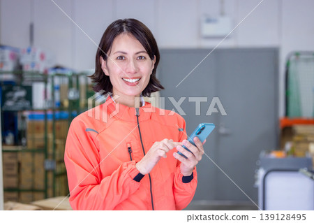倉庫——女子正在看她的智慧型手機 139128495