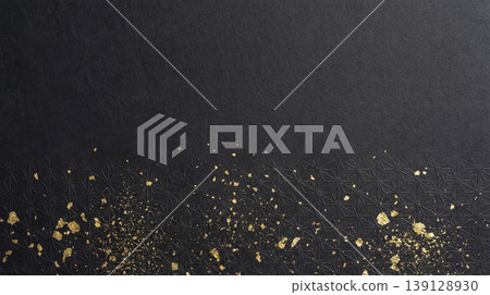 A modern Japanese background featuring a hemp leaf pattern and gold leaf at the bottom of a black washi paper surface. 139128930