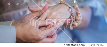 Groom show wedding ring on the box before give to bride in wedding ceremony. Groom show wedding ring on the box before give to bride in wedding ceremony. 139129462