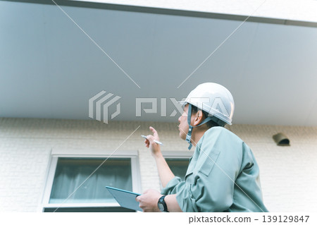 A company that inspects the soffit under the balcony. 139129847