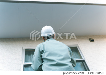 A company that inspects the soffit under the balcony. 139129850
