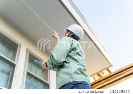 A company that inspects the soffit under the balcony. 139129855