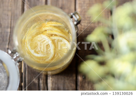 Homemade lemon syrup made in a sealed jar Homemade lemon syrup made in a sealed jar 139130026