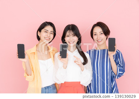 Middle woman using a smartphone Middle woman using a smartphone 139130029