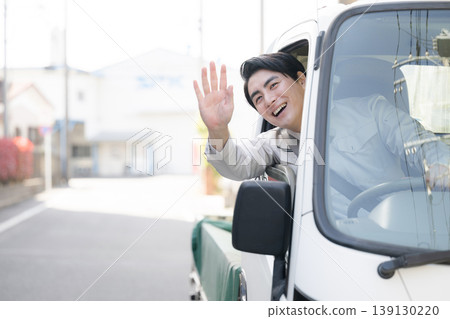 Smiling portraits of workers leaning out of car windows during deliveries and travel, smiling, looking at the camera, and waving in greeting. Smiling portraits of workers leaning out of car windows during deliveries and travel, smiling, looking at the camera, and waving in greeting. 139130220