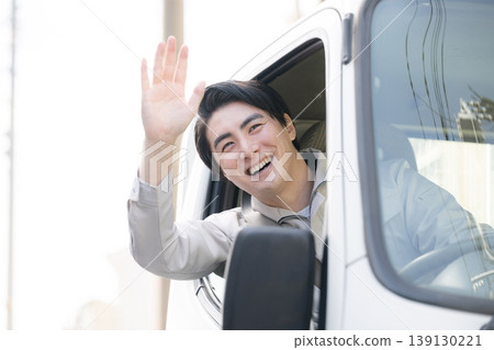 Smiling portraits of workers leaning out of car windows during deliveries and travel, smiling, looking at the camera, and waving in greeting. Smiling portraits of workers leaning out of car windows during deliveries and travel, smiling, looking at the camera, and waving in greeting. 139130221