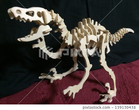 A wooden 3D puzzle that recreates the skeleton of a dinosaur. A wooden 3D puzzle that recreates the skeleton of a dinosaur. 139130438