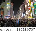 A nighttime event scene in Shibuya's bustling downtown area, with a large crowd gathered. Color halftone. 139130707