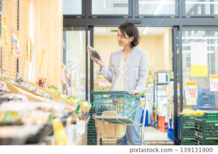 Housewife shopping at a supermarket 139131900