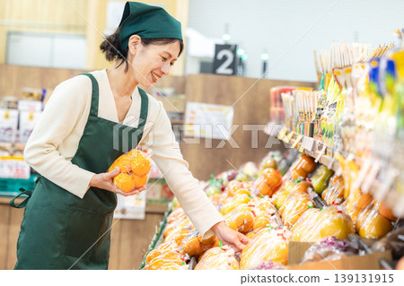 A woman who works at supermarket 139131915