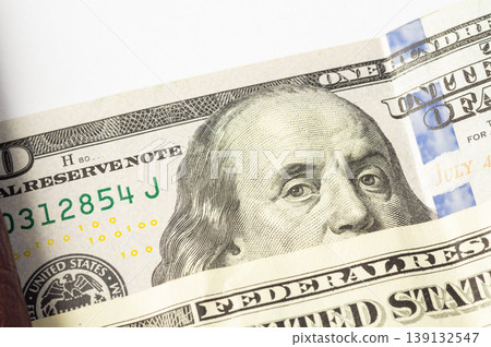 American dollar bills in close-up, showing the image of the president on the banknotes. 139132547