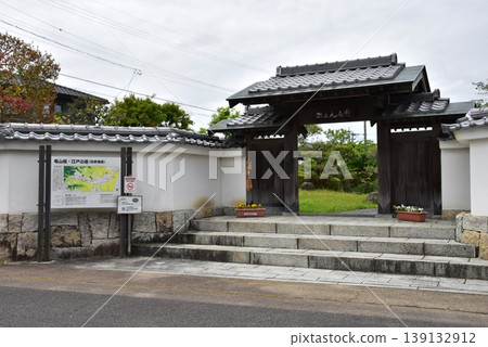 Kameyama City: Gate and old Tokaido Road information board at Nishimaru Historical Square Kameyama City: Gate and old Tokaido Road information board at Nishimaru Historical Square 139132912